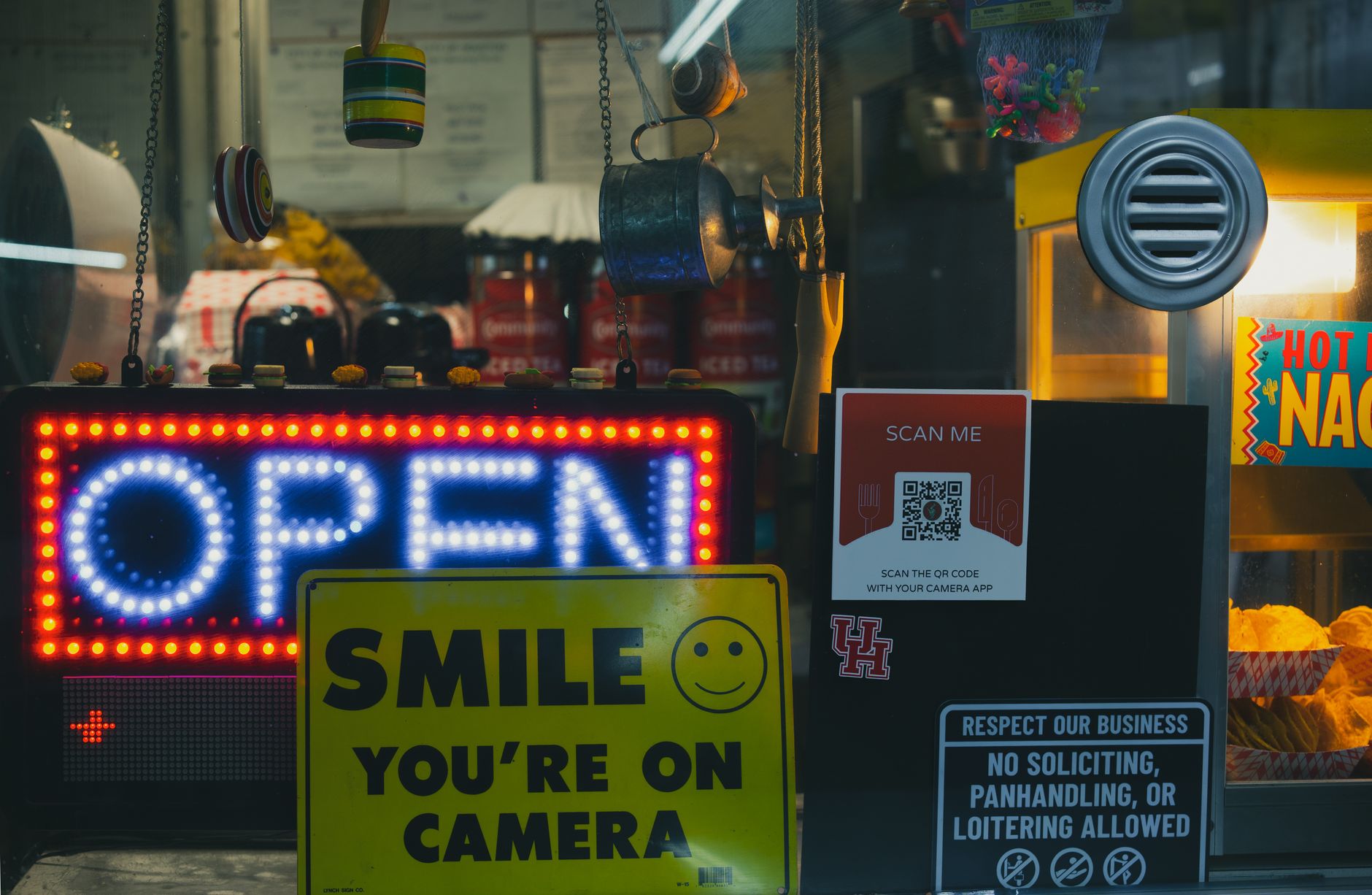 Vibrant snack stand with neon signs and food displays in Houston, Texas.